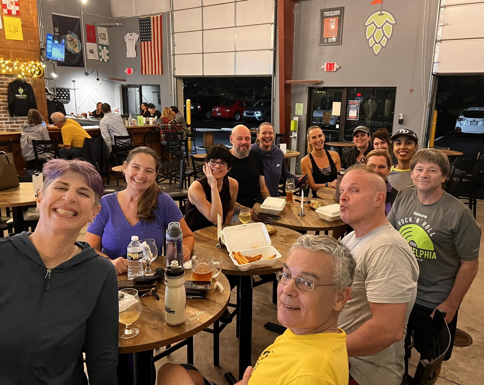 Club members gathered around tables inside the brewery
